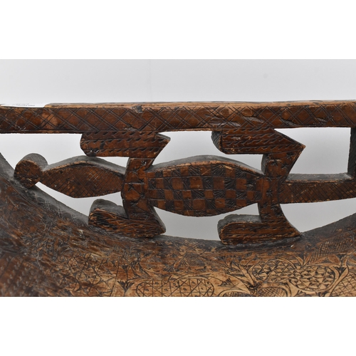 300 - An early 20th century African tribal wooden carved fruitwood stool chair. The chair with pierced bac... 