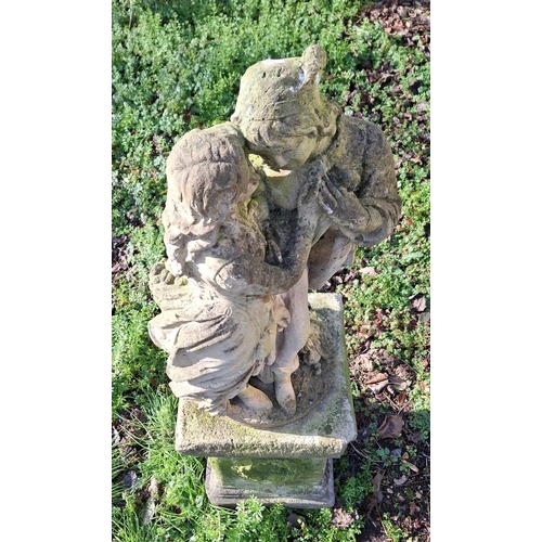 313 - A 20th century reproduction reconstituted stone classical garden statue of two lovers entwined. Rais... 