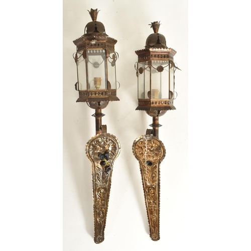 330 - A pair of Continental early 20th century embossed bronzed metal &  wooden wall lanterns / lights... 