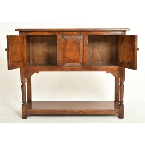 338 - A 20th century George III Revival oak Ipswich credence cupboard - sideboard. The credence having a f... 