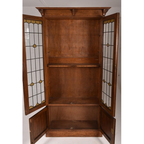 347 - An Edwardian, circa 1910 Arts & Crafts oak upright pedestal library bookcase cabinet. The cabine... 