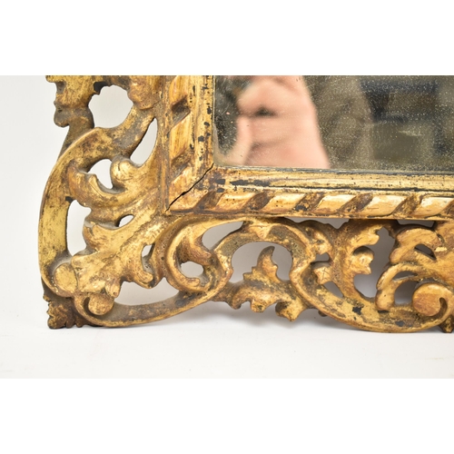 350 - An Italian 19th century Florentine gilt wood & gesso wall mirror. The mirror frame intricately c... 