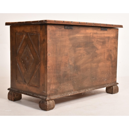 351 - An early 20th century Arts & Crafts 1926 carved walnut coffer chest. The coffer having an intric... 