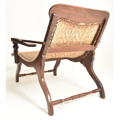 352 - An early 20th century plantation teak & wicker rattan seat lounge chair. The chair having a recl... 