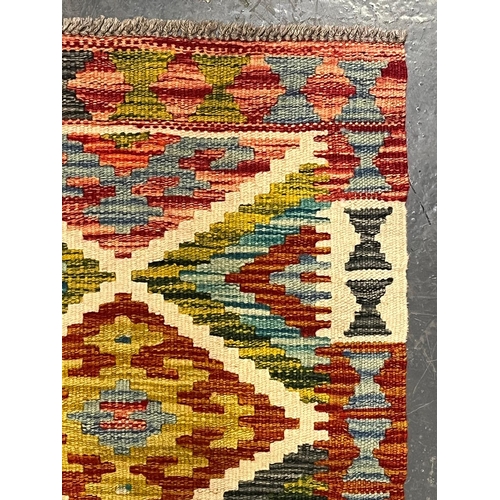 368 - A 20th century Anatolian Turkish Kilim floor carpet runner rug. The runner rug having a central pane... 