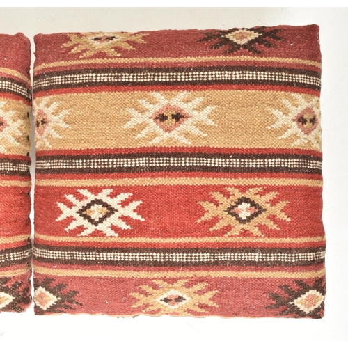 379 - A set of three country house Indian Zanskar Kilim footstools / seats. Each with multi-coloured padde... 