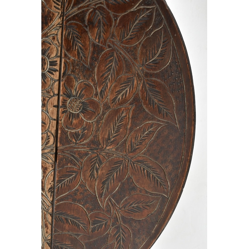 390 - Manner of Liberty & Co., London - An early 20th century carved hardwood drop leaf side hall tabl... 