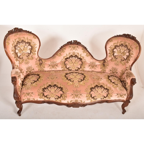 392 - A late 19th century Victorian carved mahogany double-head sofa settee. The sofa having a carved doub... 