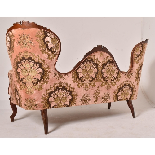 392 - A late 19th century Victorian carved mahogany double-head sofa settee. The sofa having a carved doub... 