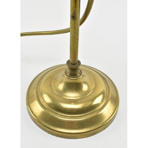 397 - An Art Nouveau early 20th century brass & glass desk table coaching lamp. The lamp having a flow... 