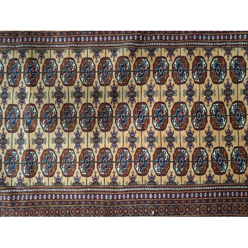 407 - An early 20th century Persian Islamic Bokhara floor carpet rug. The carpet having a central panel wi... 