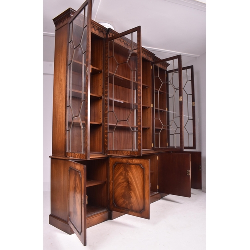 408 - George III revival flame mahogany breakfront library bookcase cupboard. The bookcase having a flared... 