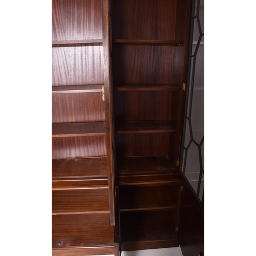 408 - George III revival flame mahogany breakfront library bookcase cupboard. The bookcase having a flared... 