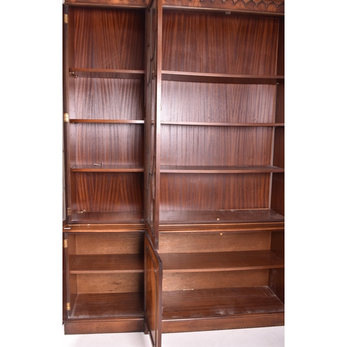 408 - George III revival flame mahogany breakfront library bookcase cupboard. The bookcase having a flared... 