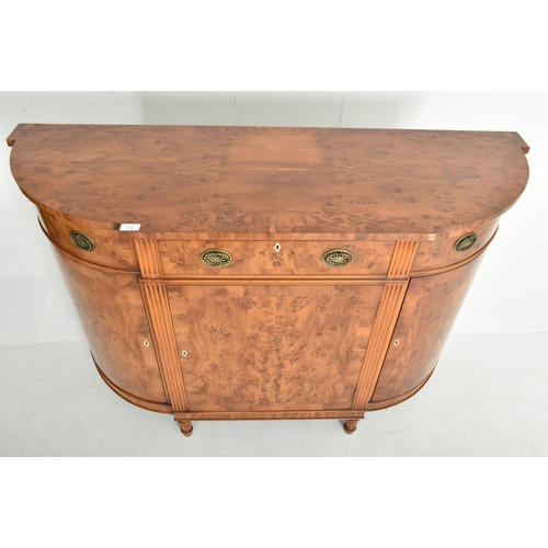 412 - Titchmarsh & Goodwin - a George III Revival yew wood bow front sideboard credenza. The sideboard... 