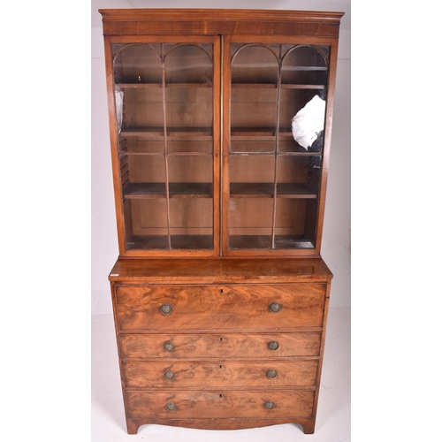 415 - A George III early 19th century mahogany secretaire bookcase. The bookcase having a flared pediment ... 