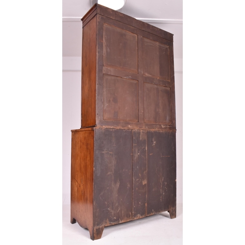 415 - A George III early 19th century mahogany secretaire bookcase. The bookcase having a flared pediment ... 