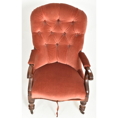 429 - A Victorian 19th century mahogany framed red buttonback armchair. The armchair featuring c-scroll te... 