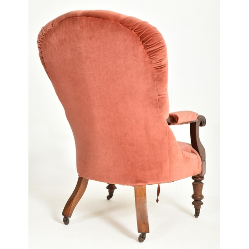 429 - A Victorian 19th century mahogany framed red buttonback armchair. The armchair featuring c-scroll te... 