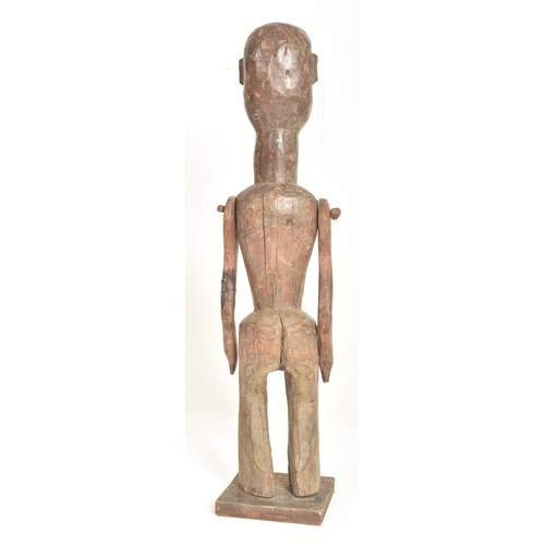 449 - An Indonesian carved wood Patung guardian sculpture. The figure having shell bead eyes with long nec... 