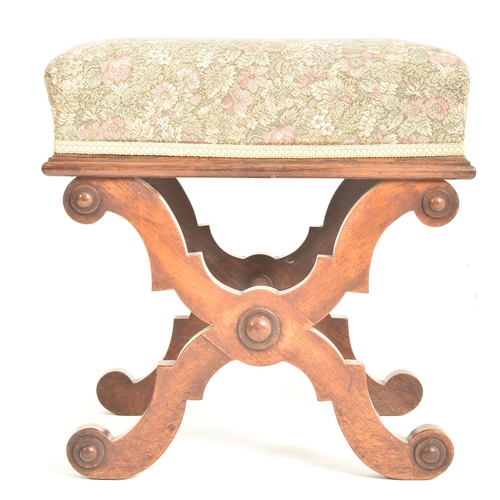 452 - A late 19th century mahogany & upholstered X-framed stool / piano seat. The stool having a padde... 