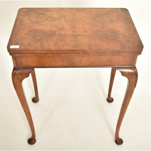 464 - A Queen Anne Revival early 20th century walnut foldover card games table. The table having a rectang... 