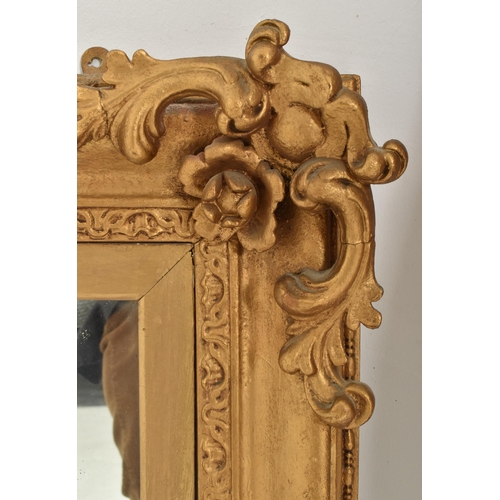 511 - A French Louis XV inspired 19th century gilt wood & gesso worked overmantel wall mirror. The mir... 