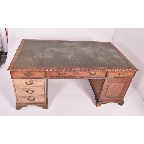 537 - A large Victorian 19th carved walnut partner's twin pedestal writing office desk. The desk having a ... 