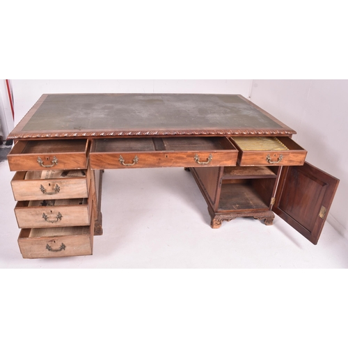 537 - A large Victorian 19th carved walnut partner's twin pedestal writing office desk. The desk having a ... 