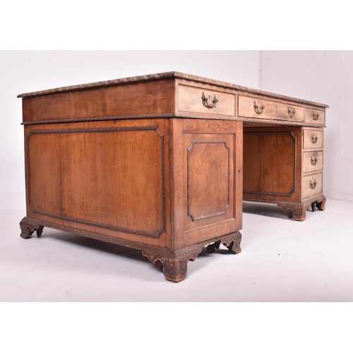 537 - A large Victorian 19th carved walnut partner's twin pedestal writing office desk. The desk having a ... 