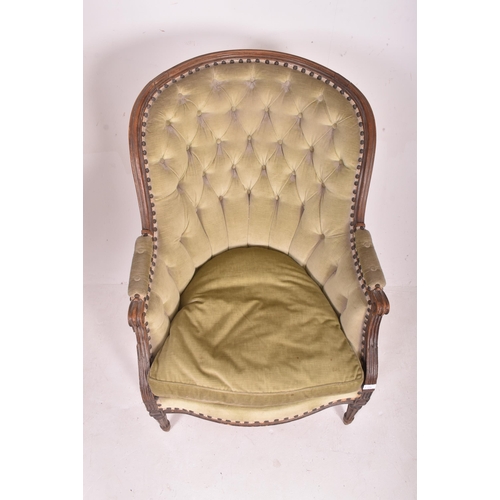 538 - A French Napoleon III 19th century oak framed salon buttoned back armchair. The chair having a scrol... 