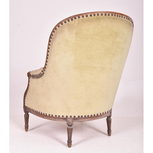 538 - A French Napoleon III 19th century oak framed salon buttoned back armchair. The chair having a scrol... 