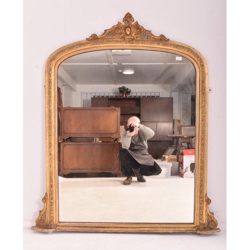 539 - A large Victorian 19th century giltwood and gesso overmantel wall mirror. The mirror having an intri... 