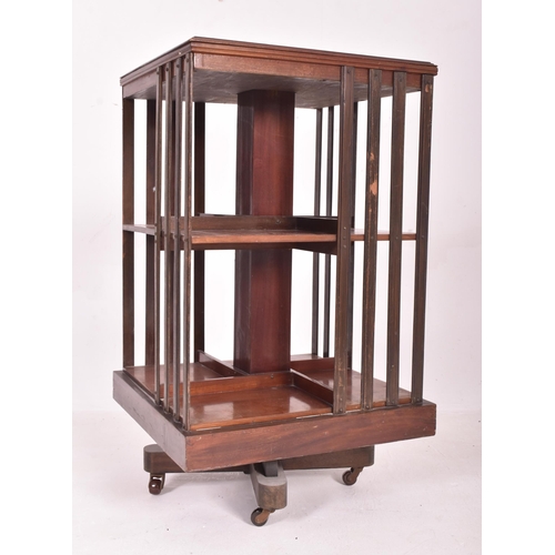 542 - An Edwardian early 20th century mahogany revolving pedestal bookcase. The bookcase having a squared ... 