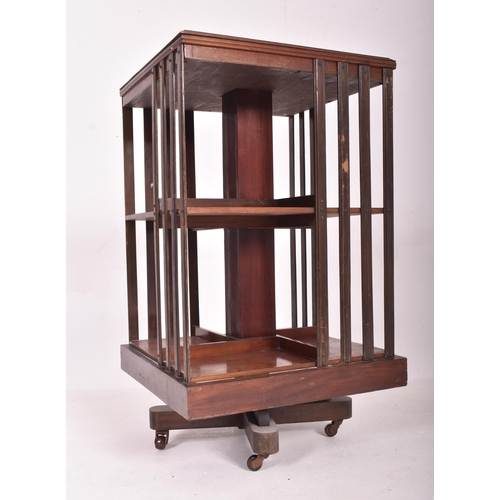 542 - An Edwardian early 20th century mahogany revolving pedestal bookcase. The bookcase having a squared ... 