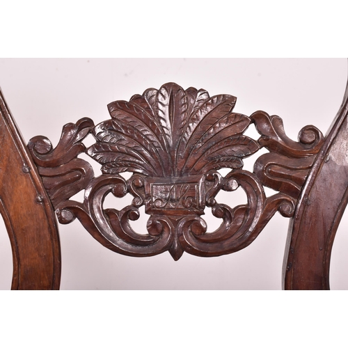 545 - An Indo - Portuguese manner hardwood and cane hall bench. The bench having a carved pierced back res... 