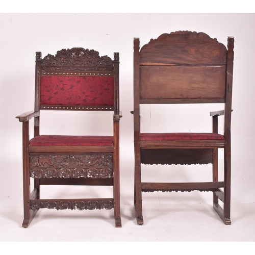 546 - A pair of 19th century carved oak hall carver chairs. Each armchair featuring carved floral and foli... 