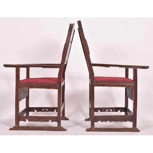 546 - A pair of 19th century carved oak hall carver chairs. Each armchair featuring carved floral and foli... 