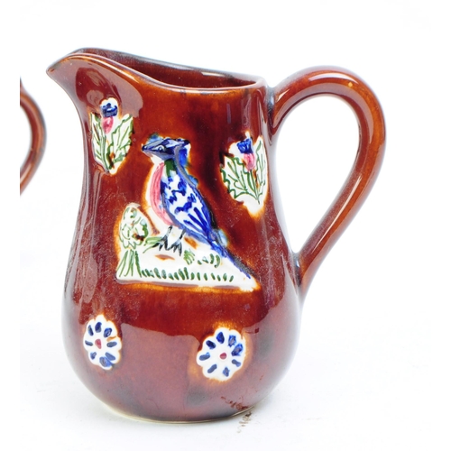 109 - Collection of early 20th century Measham bargeware including two teapots, two mugs and a milk jug / ... 