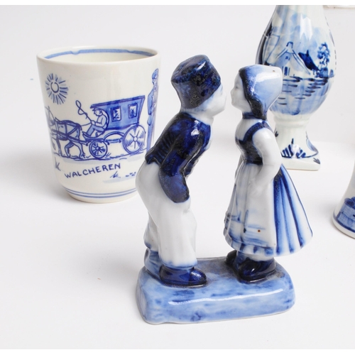 129 - Collection of 20th century Dutch Delft ware pottery pieces. Including boy and girl statues, jugs, be... 