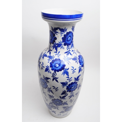 145 - Large late 20th century blue and white floral ceramic vase with a blue decorative border to the flar... 