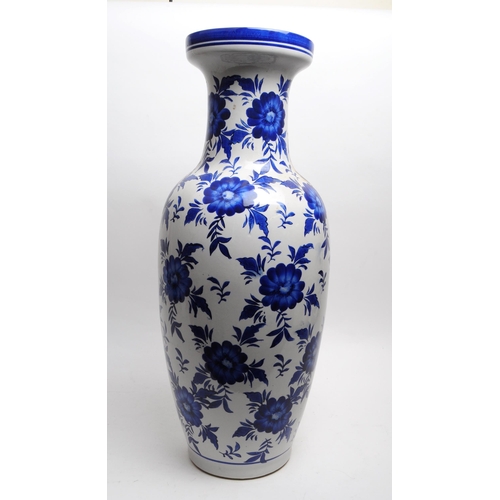 145 - Large late 20th century blue and white floral ceramic vase with a blue decorative border to the flar... 