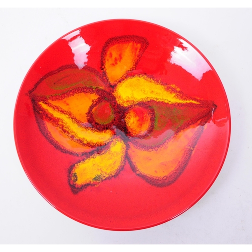 148 - Three 1970s Poole pottery Delphis patterned pieces comprised of a bowl and two plates in a red and o... 