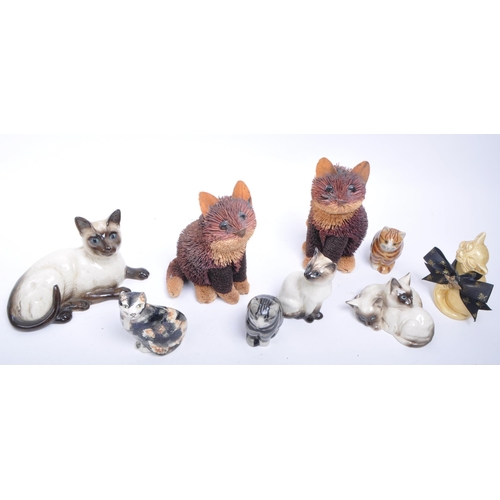 189 - Collection of 20th century porcelain and pottery cat figurines, comprised of two Royal Doulton siame... 