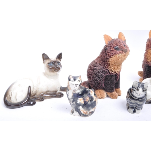 189 - Collection of 20th century porcelain and pottery cat figurines, comprised of two Royal Doulton siame... 