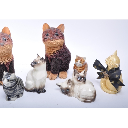 189 - Collection of 20th century porcelain and pottery cat figurines, comprised of two Royal Doulton siame... 