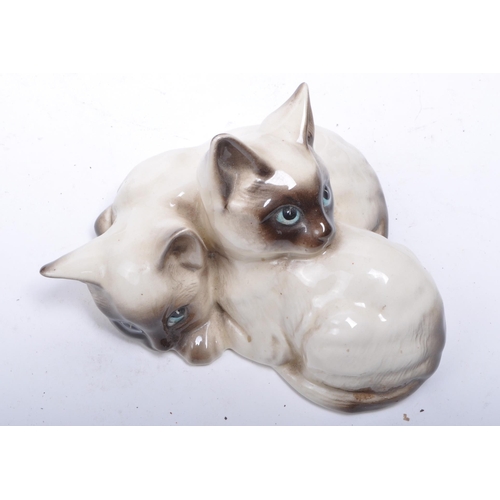 189 - Collection of 20th century porcelain and pottery cat figurines, comprised of two Royal Doulton siame... 