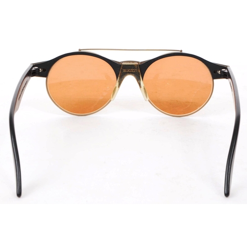 214 - Swatch - A pair of vintage 20th century Swatch sunglasses. The sunglasses having black molded plasti... 