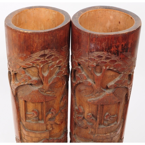 220 - A pair of 20th century Chinese bamboo brush pot vases. Each with a carved relief design depicting a ... 