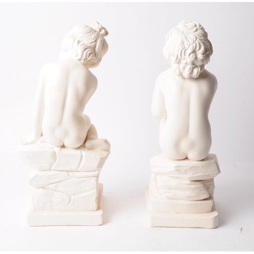 221 - A pair of two late 20th century plaster cherub figures, a boy and a girl depicted sitting on rocks. ... 